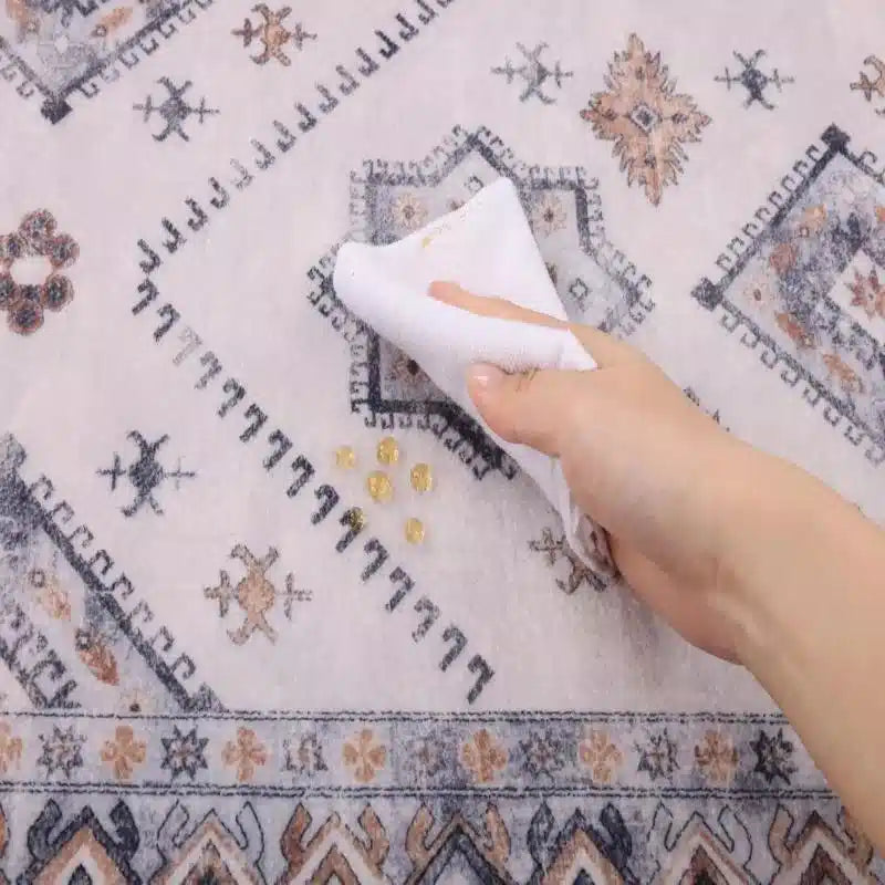 Cleaning_a_stain_off_a_Heberug_stain-resistant_modern_geometric_runner_rug_with_a_cloth.
